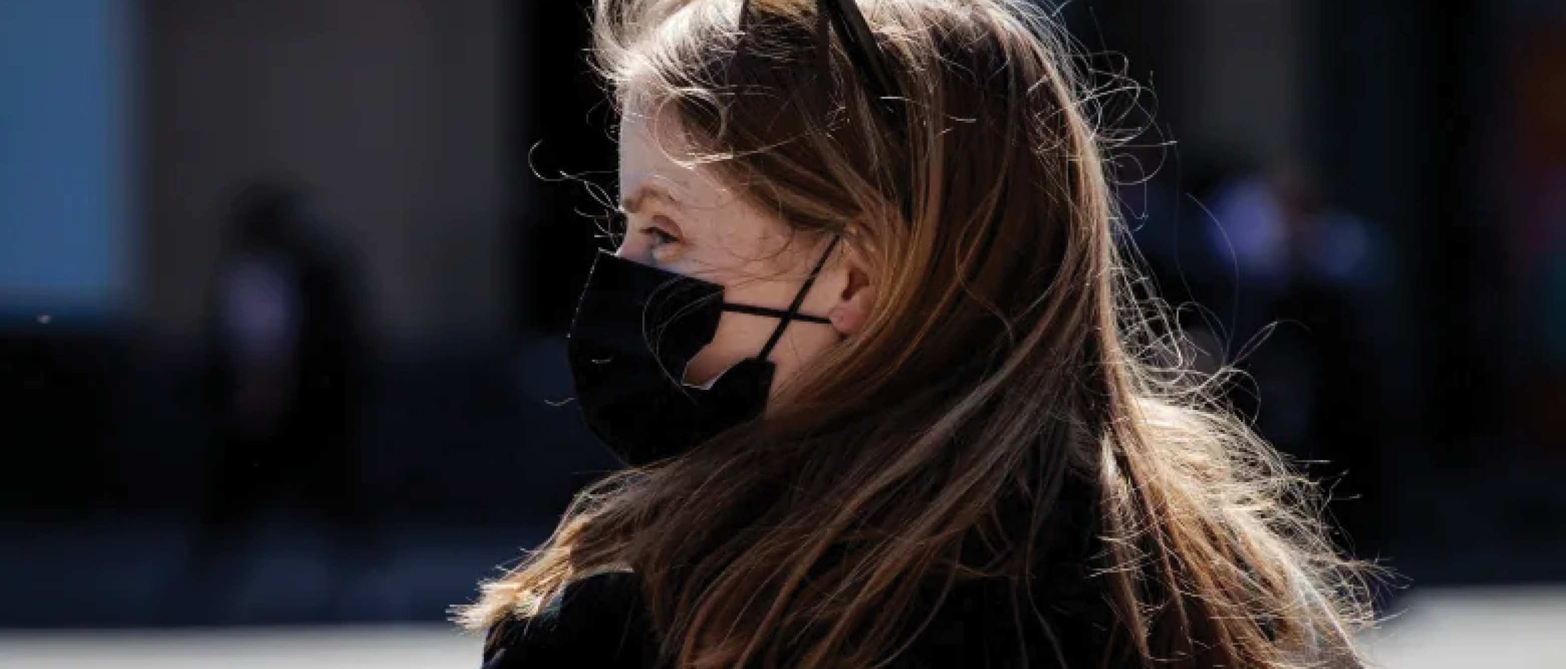 Profile of woman wearing a black mask. Image: CBC.