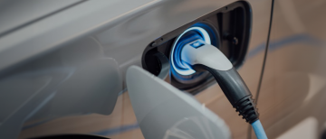 Photo of electric vehicle plug charging by chuttersnap on Unsplash.